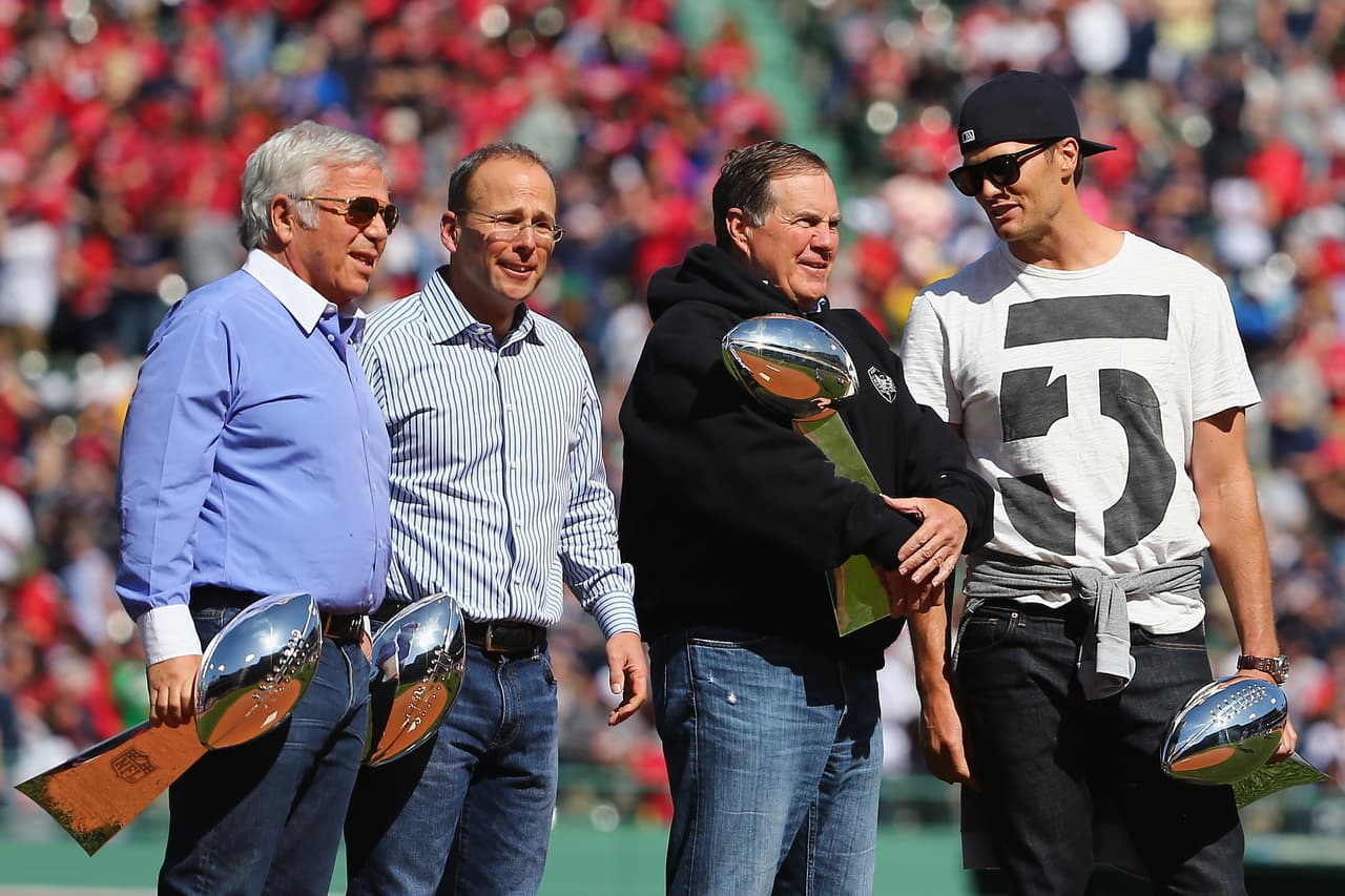 BOSTON, MA - APRIL 13: From left, New England Patriots owner Robert Kraft, New England Patriots President Jonathan Kraft, head coach Bill Belichick and quarterback Tom Brady hold Vince Lombardi trophies on the pitchers mound at Fenway Park on April 13, 2015 in Boston, Massachusetts. (Photo by Maddie Meyer/Getty Images)