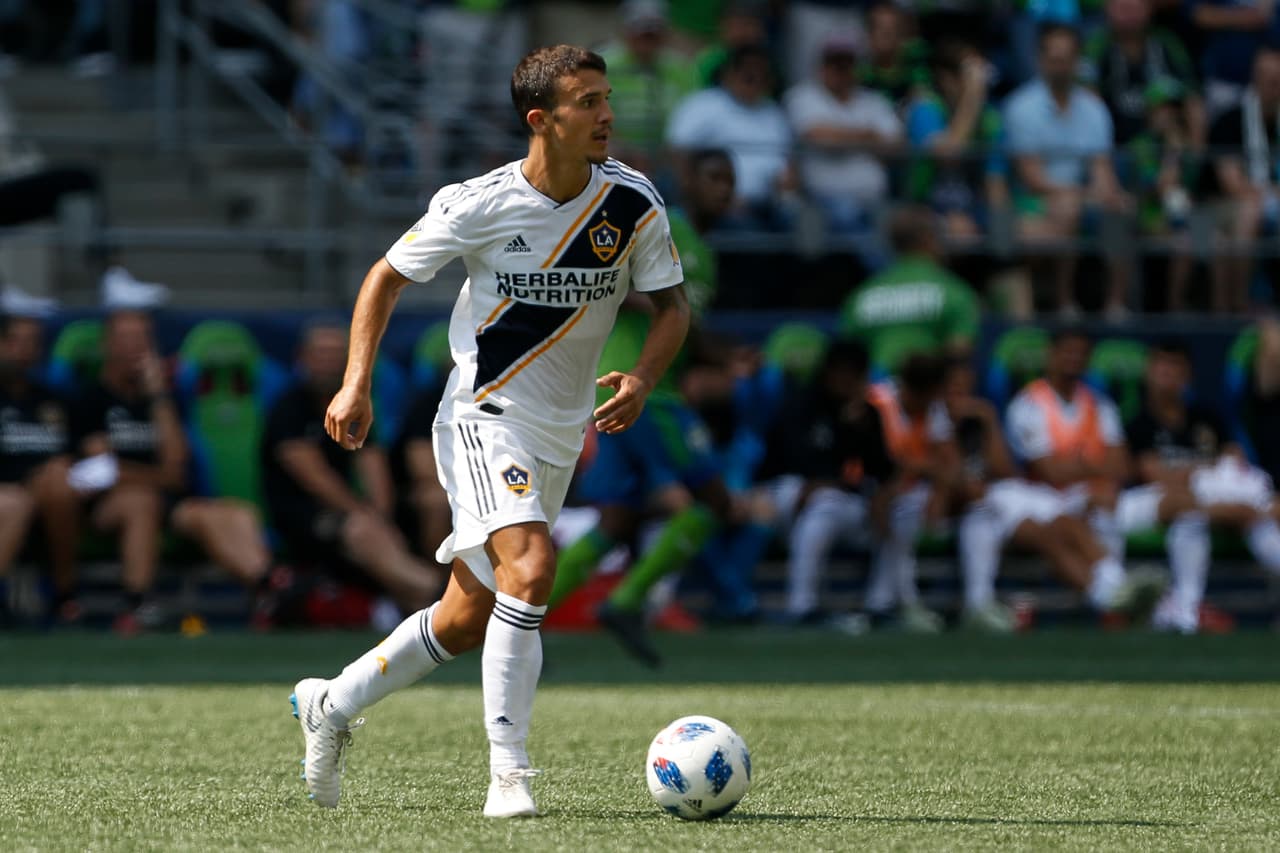 Aug 18, 2018; Seattle, WA, USA; Los Angeles Galaxy midfielder Servando Carrasco (14) dribbles the ball against the Seattle Sounders FC during the second half at CenturyLink Field. Mandatory Credit: Jennifer Buchanan-USA TODAY Sports