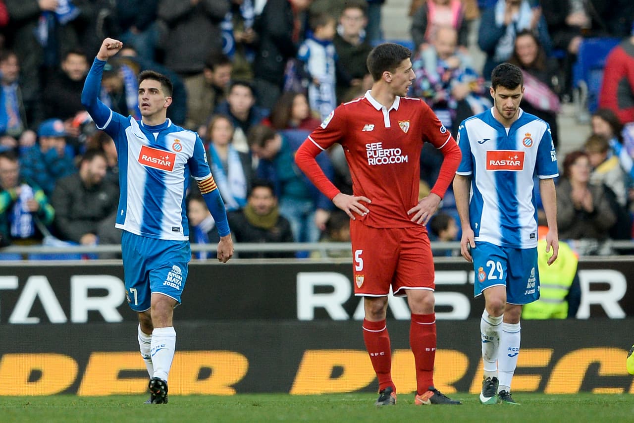 Espanyol's forward Gerard Moreno (L) celebrates his goal beside Sevilla's French defender Clement Lenglet (C) and Espanyol's defender Aaron Caricol during the Spanish league football match RCD Espanyol vs Sevilla FC at the Cornella-El Prat stadium in Cornella de Llobregat on January 29, 2017. / AFP / Josep Lago (Photo credit should read JOSEP LAGO/AFP/Getty Images)