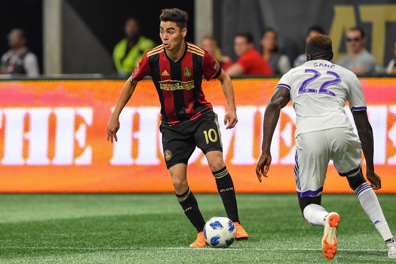 Jun 30, 2018; Atlanta, GA, USA; Atlanta United midfielder Miguel Almiron (10) controls the ball in front of Orlando City defender Lamine Sane (22) during the first half at Mercedes-Benz Stadium. Mandatory Credit: Dale Zanine-USA TODAY Sports