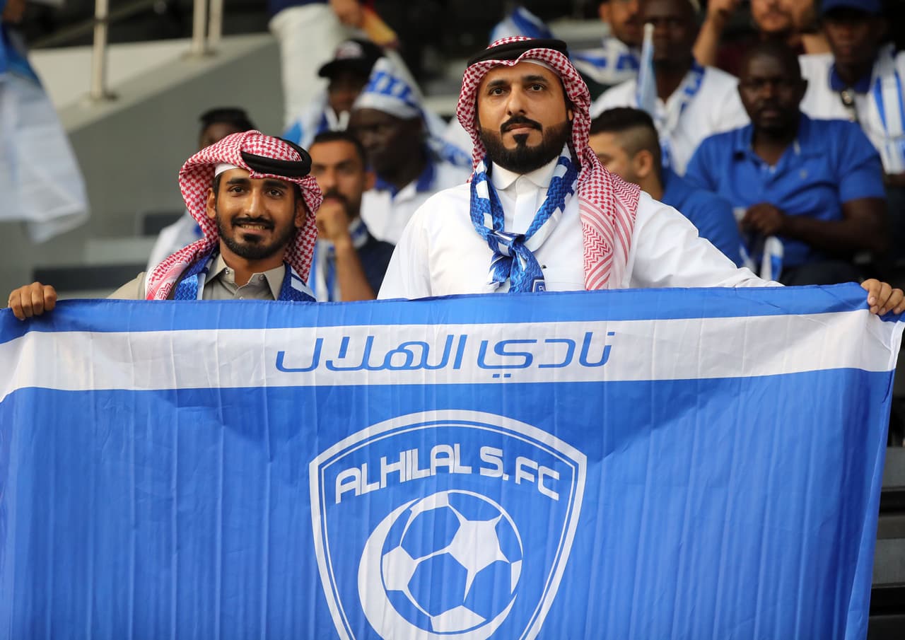 Fans of Hilal pose for a picture with their team's flag ahead of the 2019 FIFA Club World Cup quarter-final football match between Hilal and Esperance de Tunis at Jassim Bin Hamad Stadium in Doha on December 14, 2019. (Photo by KARIM JAAFAR / AFP) (Photo by KARIM JAAFAR/AFP via Getty Images)
