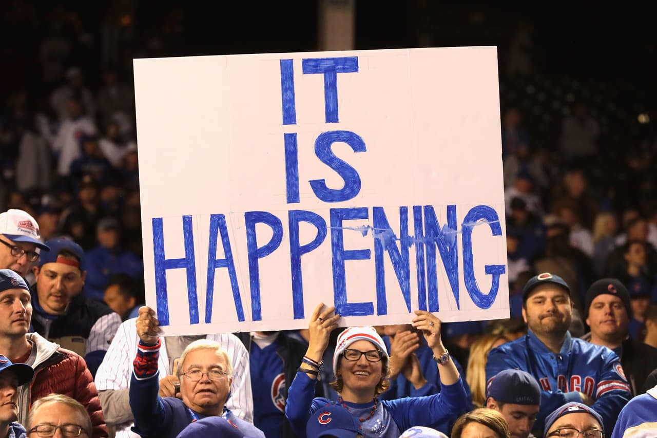 CHICAGO, IL - OCTOBER 22: Chicago Cubs fans hold a sign after the Chicago Cubs defeated the Los Angeles Dodgers 5-0 in game six of the National League Championship Series to advance to the World Series against the Cleveland Indians at Wrigley Field on October 22, 2016 in Chicago, Illinois. (Photo by Jamie Squire/Getty Images)