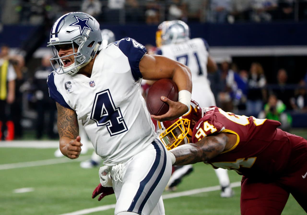 Dallas Cowboys quarterback Dak Prescott (4) escapes pressure from Washington Redskins linebacker Preston Smith (94) in the first half of an NFL football game, Thursday, Nov. 30, 2017, in Arlington, Texas. (AP Photo/Michael Ainsworth)