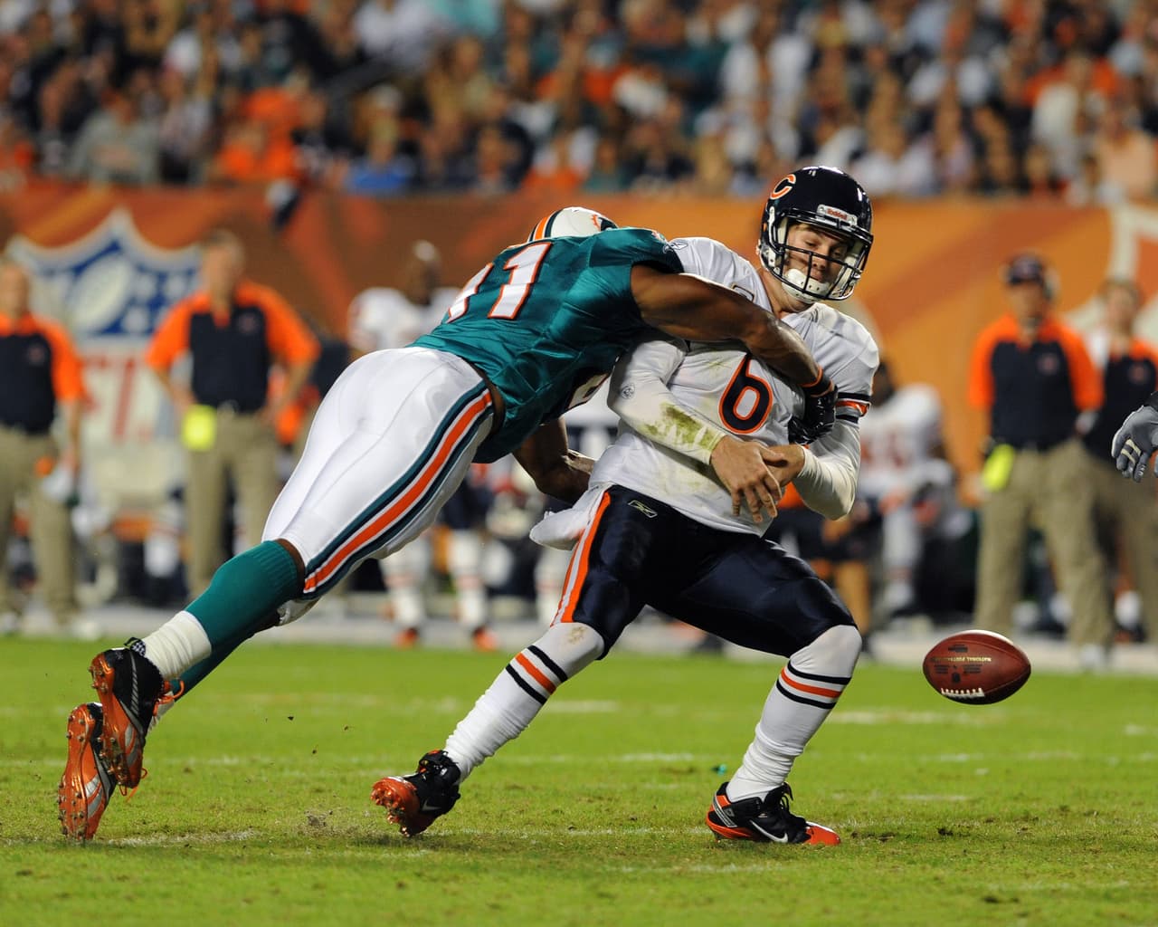 Linebacker Cameron Wake (91) of the Miami Dolphins forces a fumble by quarterback Jay Cutler (6) of the Chicago Bears Nov. 18, 2010 at Sun Life Stadium in Miami. (Al Messerschmidt via AP)