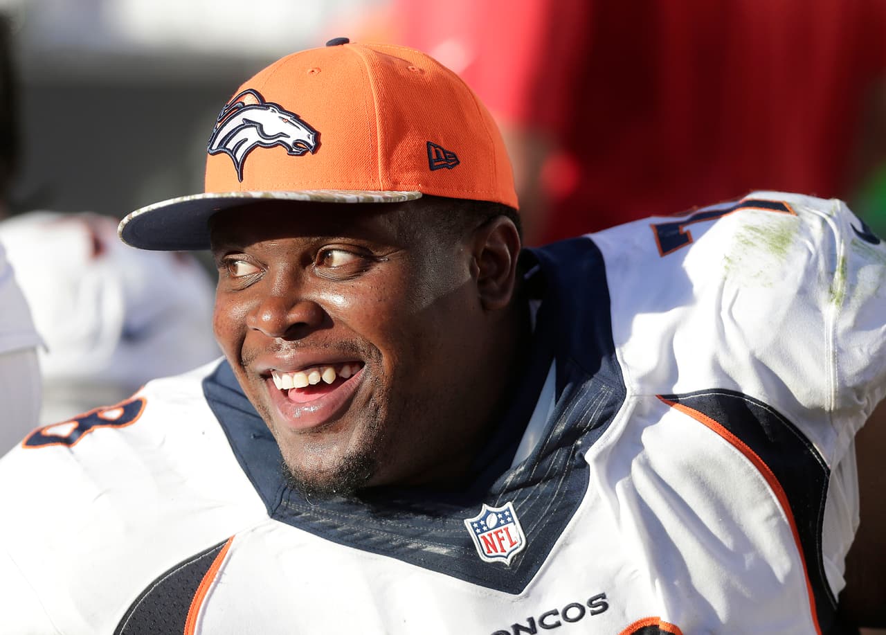 Denver Broncos offensive tackle Ryan Clady (78) smiles on the sideline during the fourth quarter of an NFL football game against the Oakland Raiders in Oakland, Calif., Sunday, Nov. 9, 2014. The Broncos won 41-17. (AP Photo/Marcio Jose Sanchez)