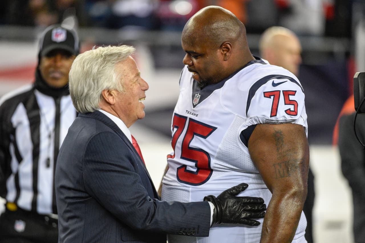 New England Patriots owner, Chairman and Chief Executive Officer of The Kraft Group Robert Kraft speaks with Houston Texans and former New England Patriots defensive tackle Vince Wilfork (75) at midfield prior to the NFL AFC Divisional football game on Saturday, Jan. 14, 2017 in Foxboro, Mass. The Patriots defeated the Texans 34-16. (Jim Mahoney via AP)