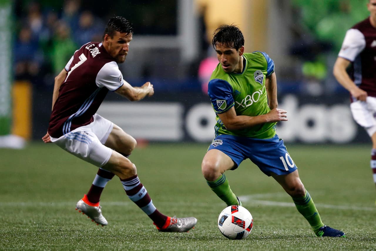 Nov 22, 2016; Seattle, WA, USA; Seattle Sounders FC midfielder Nicolas Lodeiro (10) cuts the ball back against Colorado Rapids midfielder Sebastien Le Toux (7) during the first half in the first leg of the MLS Western Conference Championship at CenturyLink Field. Seattle won 2-1. Mandatory Credit: Jennifer Buchanan-USA TODAY Sports