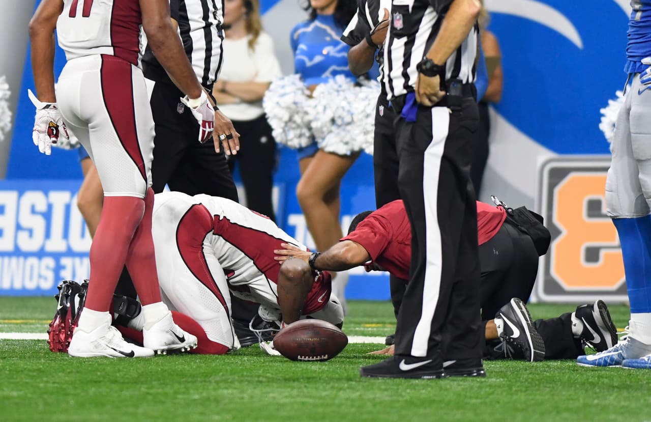 Arizona Cardinals running back David Johnson (31) is checked by team trainers for injury against the Detroit Lions during the second half of an NFL football game in Detroit, Sunday, Sept. 10, 2017. (AP Photo/Jose Juarez)