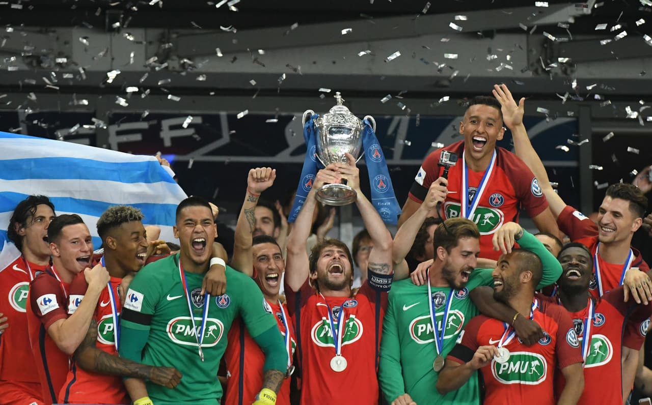 Paris Saint-Germain's Brazilian defender Maxwell (C) holds the trophy as he celebrates with teammate after winning the French Cup final football match between Paris Saint-Germain (PSG) and Angers (SCO) on May 27, 2017, at the Stade de France in Saint-Denis, north of Paris. / AFP PHOTO / Jean-Francois MONIER (Photo credit should read JEAN-FRANCOIS MONIER/AFP/Getty Images)