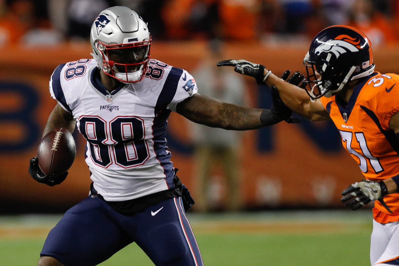 New England Patriots tight end Martellus Bennett (88) runs with the ball after a catch in front of Denver Broncos safety Justin Simmons (31) during an NFL football game on Sunday, Nov. 12, 2017 in Denver. New England won 41-16. (Peter Read Miller via AP)