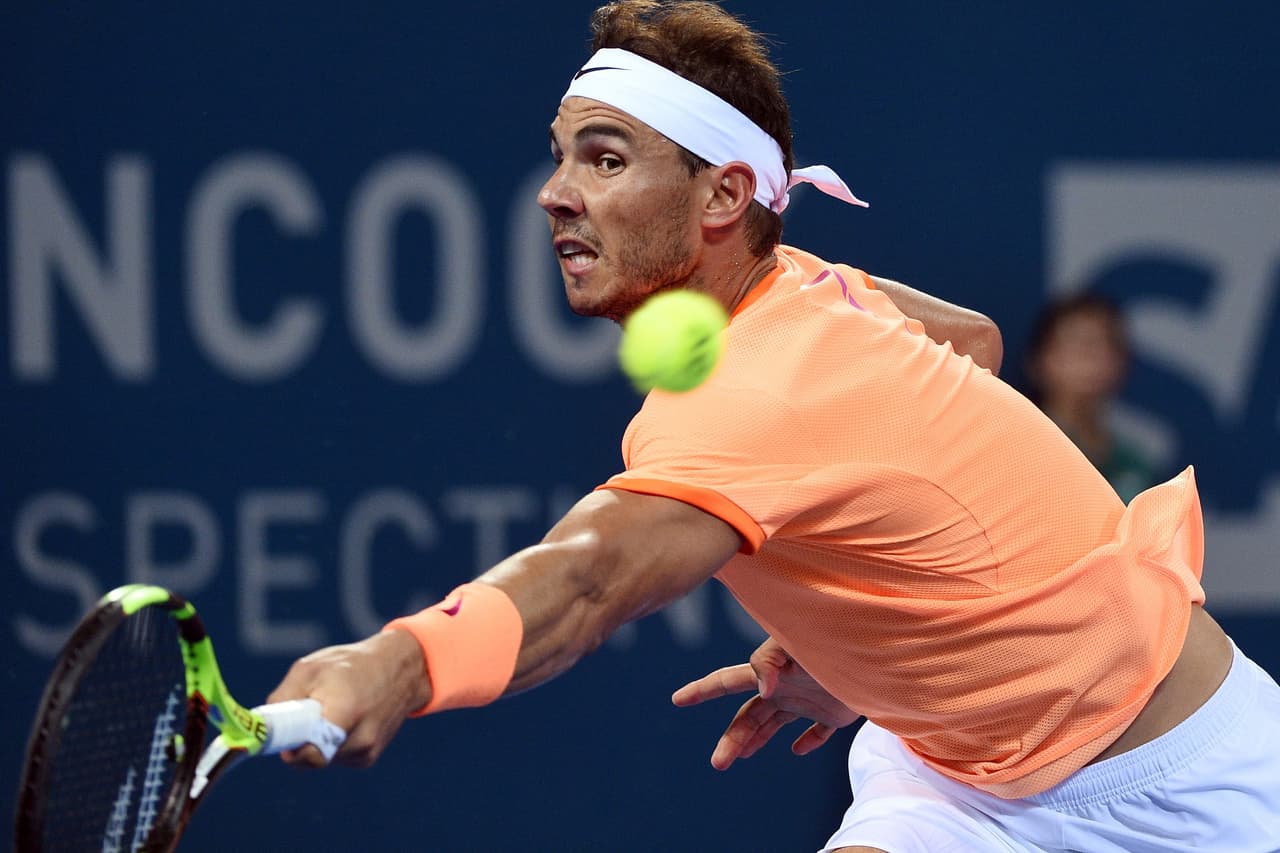 Rafael Nadal of Spain hits a return against Milos Raonic of Canada in their men's singles quarter-final match at the Brisbane International tennis tournament in Brisbane on January 6, 2017. / AFP / Saeed KHAN / IMAGE RESTRICTED TO EDITORIAL USE - STRICTLY NO COMMERCIAL USE (Photo credit should read SAEED KHAN/AFP/Getty Images)