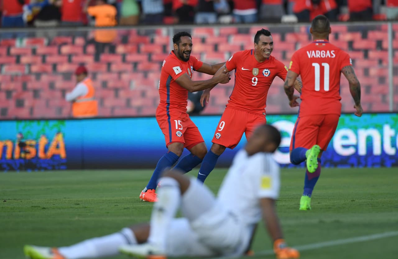 Chile's Esteban Paredes (C) celebrates with teammates after scoring against Venezuela during their 2018 FIFA World Cup qualifier football match in Santiago, Chile on March 28, 2017. / AFP PHOTO / Martin BERNETTI (Photo credit should read MARTIN BERNETTI/AFP/Getty Images)