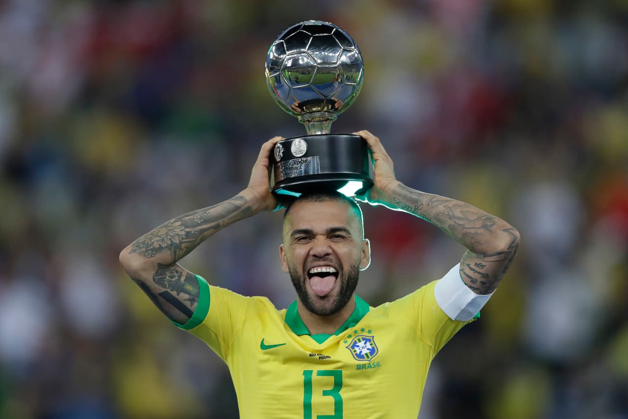 Brazil's Dani Alves celebrates with the trophy for best player of the tournament after Brazil's 3-1 victory over Peru in the final soccer match of the Copa America at the Maracana stadium in Rio de Janeiro, Brazil, Sunday, July 7, 2019. (AP Photo/Andre Penner)
