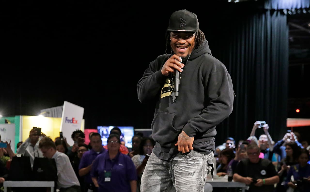 Marshawn Lynch, a former NFL football running back with the Seattle Seahawks, speaks Thursday, May 5, 2016, at a job fair in Seattle sponsored by the 100,000 Opportunities Initiative, an organization backed by Starbucks and other companies that seeks to increase employment and education opportunities for youth aged 16-24. The Seahawks announced Thursday that Lynch has been placed on the reserve/retired list. (AP Photo/Ted S. Warren)