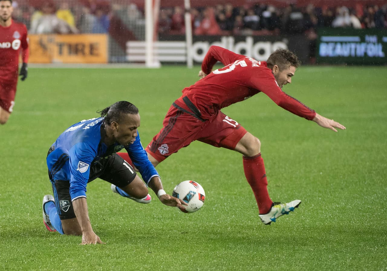 Nov 30, 2016; Toronto, Ontario, CAN; Toronto FC forward Eriq Zavaleta (15) battles for a ball with Montreal Impact forward Didier Drogba (11) during the second half of extra time in the second leg of the MLS Eastern Conference Championship at BMO Field. Toronto FC won 5-2. Mandatory Credit: Nick Turchiaro-USA TODAY Sports