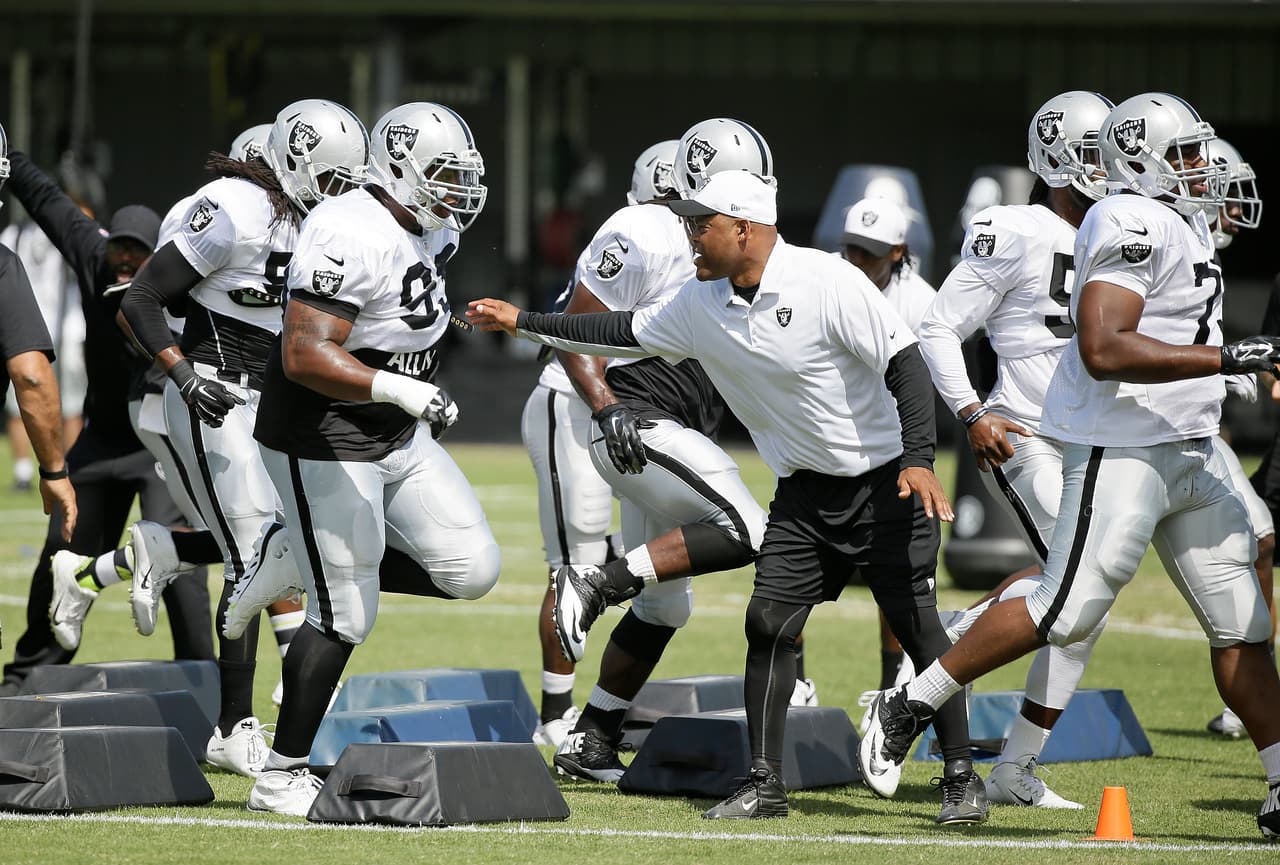 Oakland Raiders defensive coordinator Ken Norton Jr. leads players through an obstacle during their football training camp Thursday, Aug. 6, 2015, in Napa, Calif. (AP Photo/Eric Risberg)