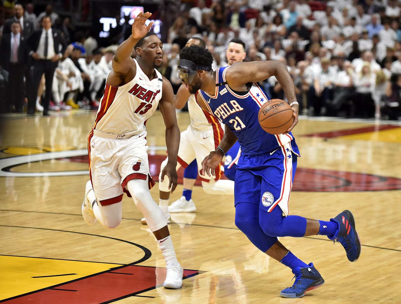 MIAMI, FL - APRIL 19: Joel Embiid #21 of the Philadelphia 76ers drives to the basket while being defended by Bam Adebayo #13 of the Miami Heat at American Airlines Arena on April 19, 2018 in Miami, Florida. NOTE TO USER: User expressly acknowledges and agrees that, by downloading and or using this photograph, User is consenting to the terms and conditions of the Getty Images License Agreement. (Photo by Eric Espada/Getty Images)