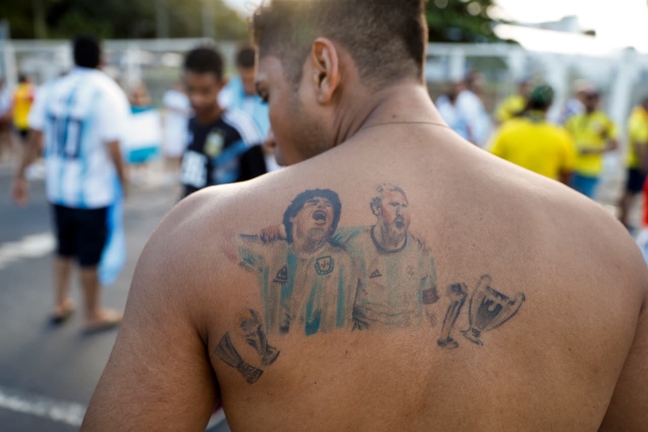 Diego Armando Maradona y Lionel Messi en el omóplato de un aficionado argentino.