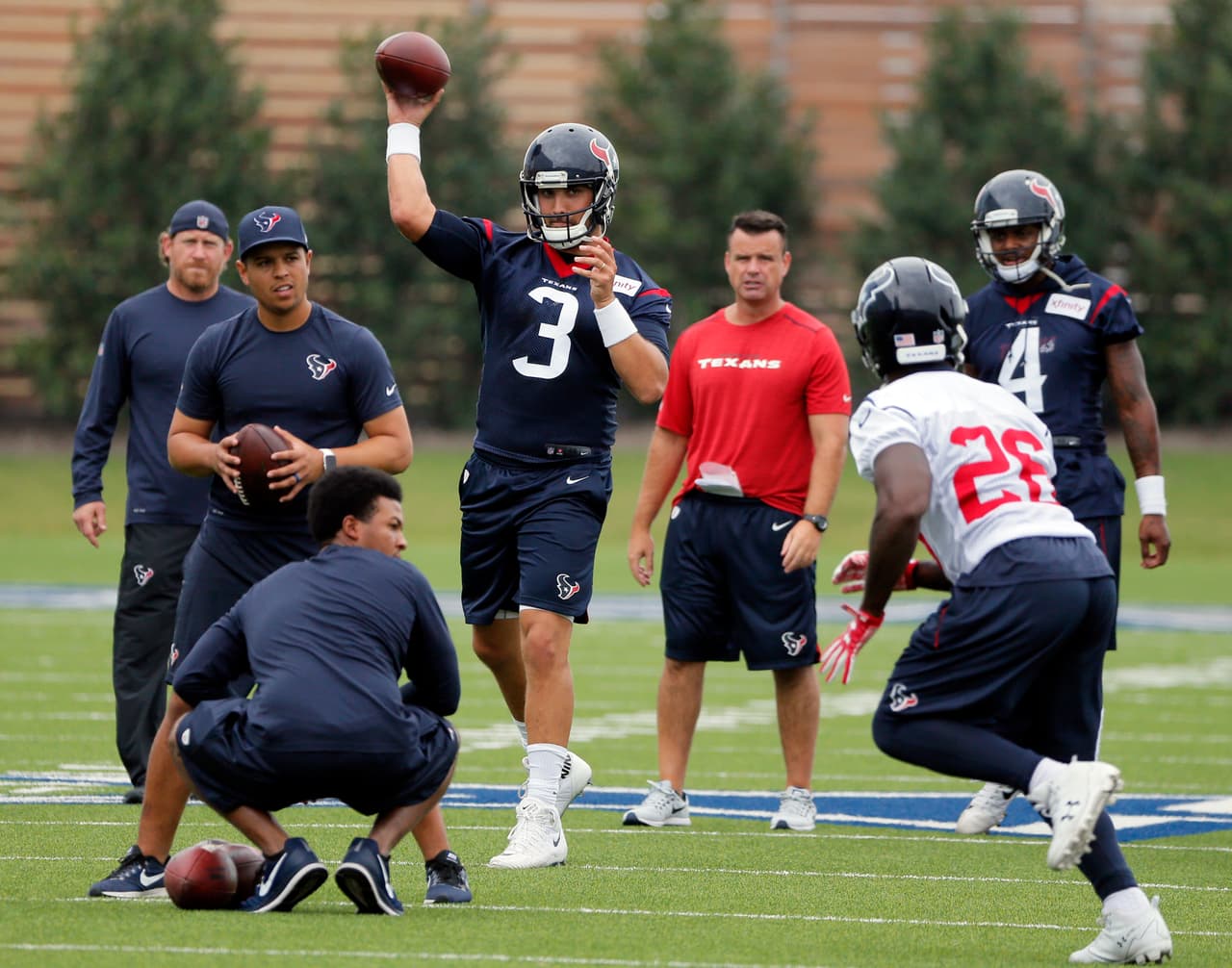 Houston Texans quarterback Tom Savage (3) throws a pass to running back Lamar Miller (26) during a morning workout at the Dallas Cowboys training facility, Monday, Aug. 28, 2017, in Frisco, Texas. The Texans are working out in the practice facility of the Dallas Cowboys because of floods pounding Houston. An exhibition game in the Texans' stadium Thursday might be moved to the home of the Cowboys. (AP Photo/Tony Gutierrez)