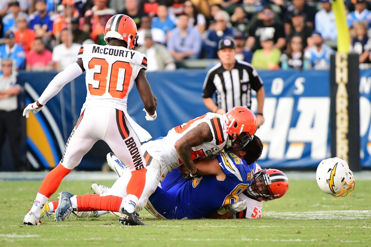 CARSON, CA - DECEMBER 03: Hunter Henry #86 of the Los Angeles Chargers loses his helmet after being tackled by Joe Schobert #53 and Christian Kirksey #58 of the Cleveland Browns during the third quarter of the game at StubHub Center on December 3, 2017 in Carson, California. (Photo by Harry How/Getty Images)