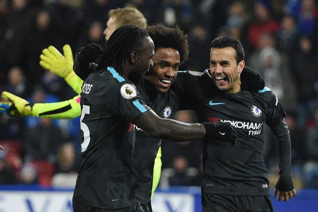 Chelsea's Spanish midfielder Pedro (R) celebrates with teammates after scoring their third goal during the English Premier League football match between Huddersfield Town and Chelsea at the John Smith's stadium in Huddersfield, northern England on December 12, 2017. / AFP PHOTO / Oli SCARFF / RESTRICTED TO EDITORIAL USE. No use with unauthorized audio, video, data, fixture lists, club/league logos or 'live' services. Online in-match use limited to 75 images, no video emulation. No use in betting, games or single club/league/player publications. / (Photo credit should read OLI SCARFF/AFP/Getty Images)
