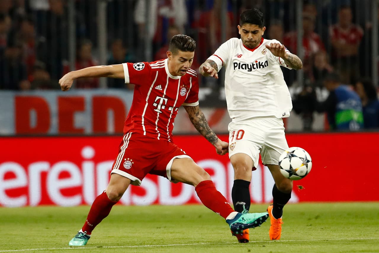 Bayern Munich's Colombian midfielder James Rodriguez (L) vies with Sevilla's Argentinian midfielder Ever Banega during the UEFA Champions League quarter-final second leg football match between Bayern Munich and Sevilla FC on April 11, 2018 in Munich, southern Germany. / AFP PHOTO / Odd ANDERSEN (Photo credit should read ODD ANDERSEN/AFP/Getty Images)