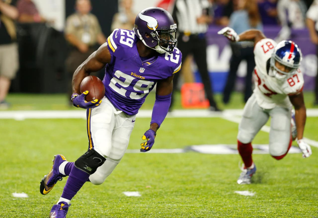 Minnesota Vikings cornerback Xavier Rhodes (29) runs from New York Giants wide receiver Sterling Shepard (87) after intercepting a pass during the second half of an NFL football game Monday, Oct. 3, 2016, in Minneapolis. (AP Photo/Jim Mone)