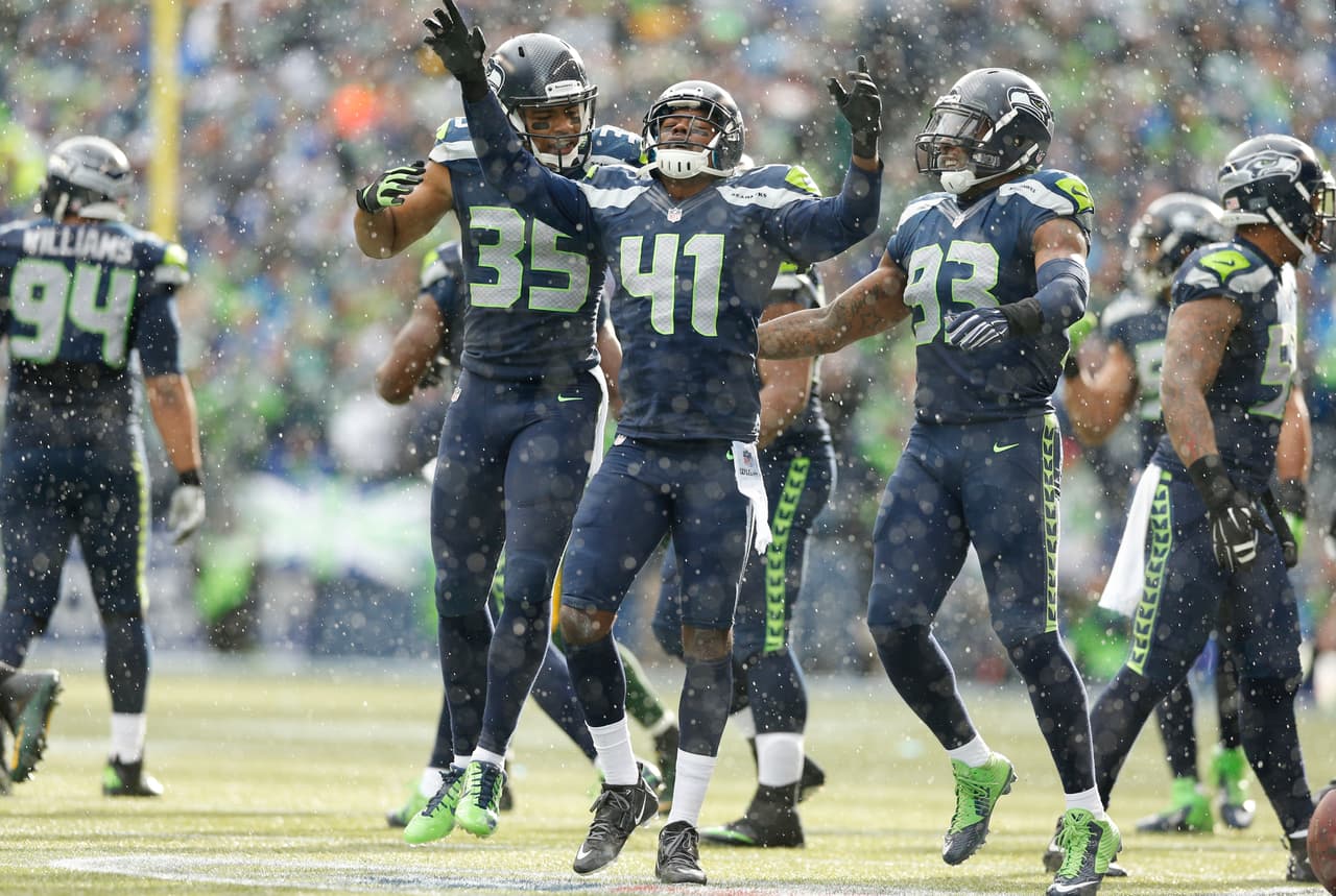 Seattle Seahawks cornerback Byron Maxwell (41) celebrates an interception with defensive back DeShawn Shead (35) and defensive end O'Brien Schofield (93) during an NFC Championship playoff football game against the Green Bay Packers on Sunday, Jan. 18, 2015 at CenturyLink Field in Seattle, WA. (AP Photo/Ric Tapia)