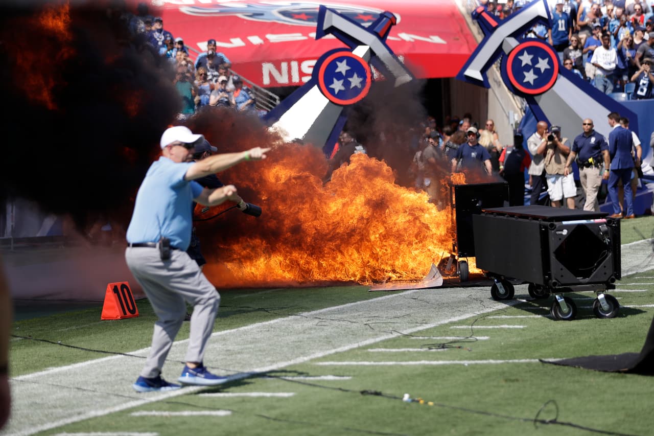 A fire from a pyrotechnics machine burns on the field before an NFL football game between the Tennessee Titans and the Indianapolis Colts Sunday, Sept. 15, 2019, in Nashville, Tenn. (AP Photo/James Kenney)
