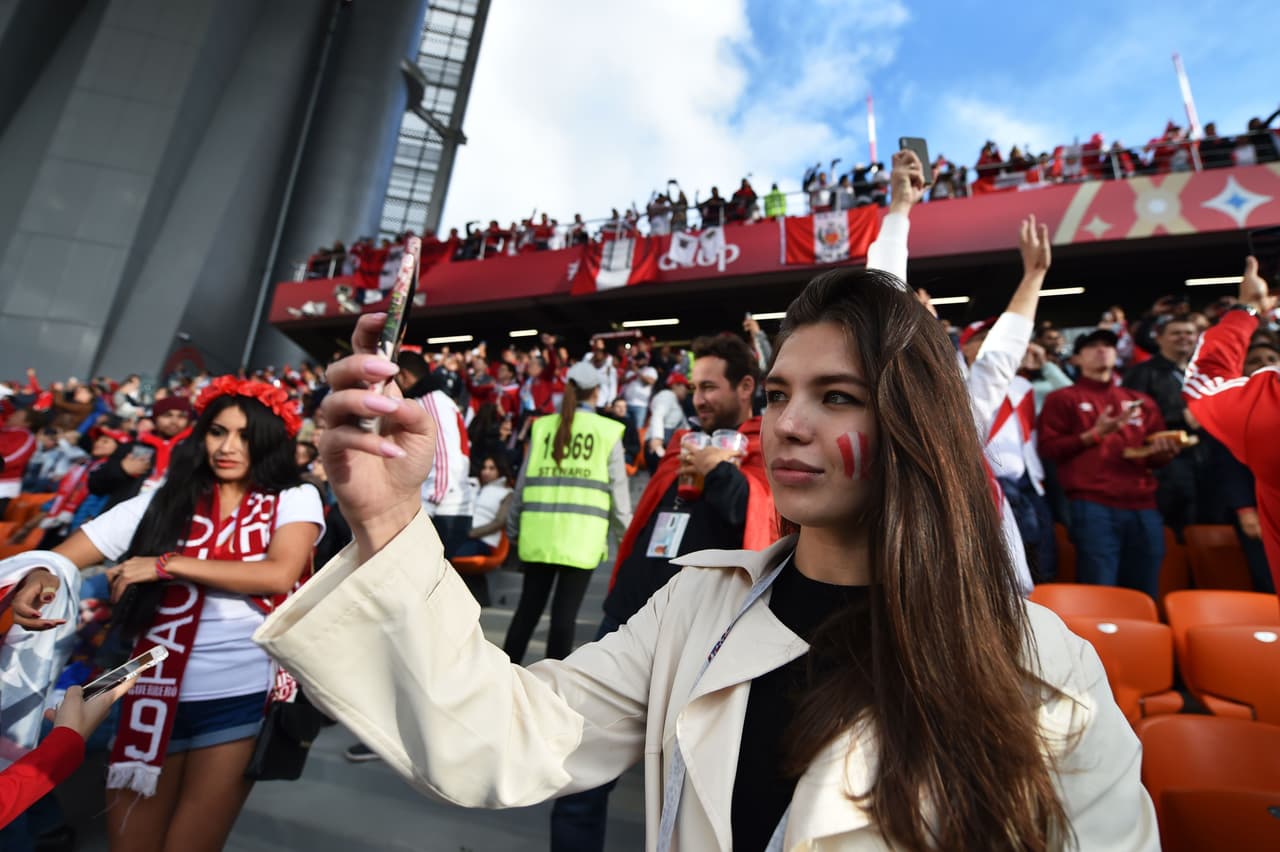 A Peru fan uses her mobile phone before the Russia 2018 World Cup Group C football match between France and Peru at the Ekaterinburg Arena in Ekaterinburg on June 21, 2018. (Photo by HECTOR RETAMAL / AFP) / RESTRICTED TO EDITORIAL USE - NO MOBILE PUSH ALERTS/DOWNLOADS (Photo credit should read HECTOR RETAMAL/AFP/Getty Images)