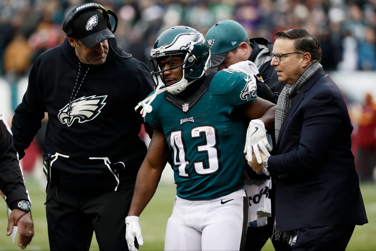 Philadelphia Eagles' Darren Sproles is led off the field with Philadelphia Eagles' head coach Doug Pederson after taking a hit during the second half of an NFL football game, Sunday, Dec. 11, 2016, in Philadelphia. (AP Photo/Michael Perez)