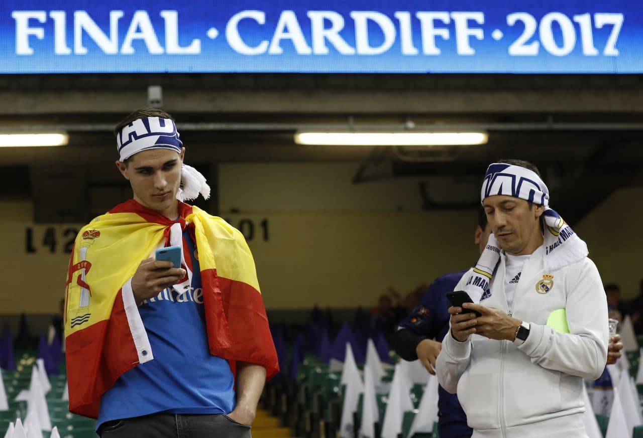 En el Millennium Stadium, donde rodará el balón en unas horas, los aficionados esperan y se ayudan de sus teléfonos móviles para distraerse.