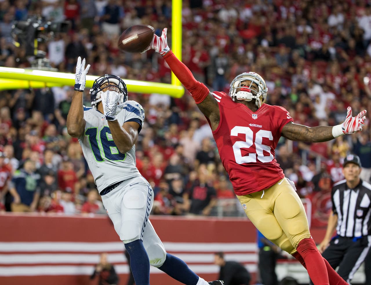 Seattle Seahawks wide receiver Tyler Lockett (16) catches a 43-yard touchdown pass during an NFL game over the out-stretched hand of San Francisco 49ers defensive back Tramaine Brock (26) on Thursday, Oct. 22, 2015, in Santa Clara, CA. The Seahawks won the game, 20-3. (Greg Trott via AP)