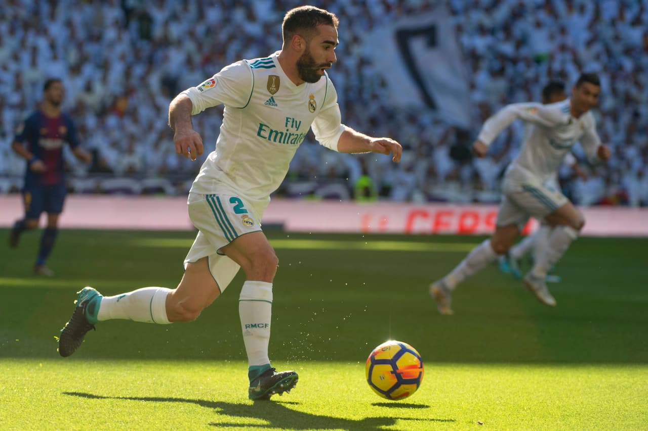 Real Madrid's Spanish defender Dani Carvajal runs with the ball during the Spanish League "Clasico" football match Real Madrid CF vs FC Barcelona at the Santiago Bernabeu stadium in Madrid on December 23, 2017. / AFP PHOTO / CURTO DE LA TORRE (Photo credit should read CURTO DE LA TORRE/AFP/Getty Images)