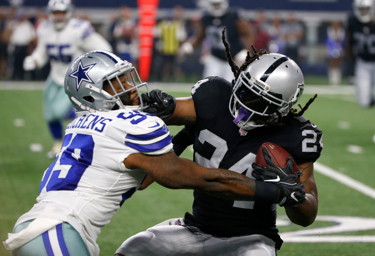 Dallas Cowboys linebacker Anthony Hitchens (59) tries to stop Oakland Raiders running back Marshawn Lynch (24) on a run in the first half of a preseason NFL football game, Saturday, Aug. 26, 2017, in Arlington, Texas. (AP Photo/Ron Jenkins)