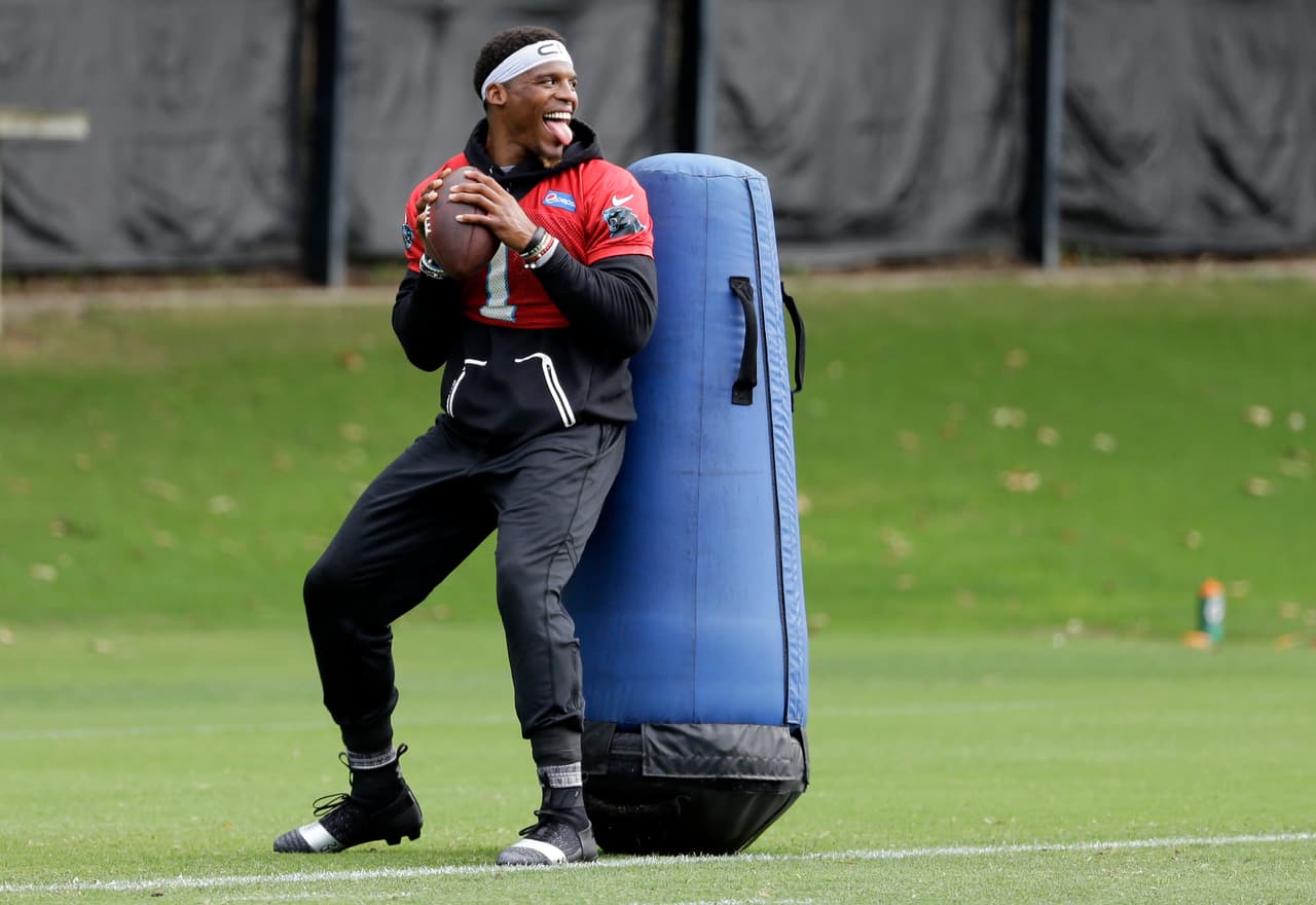Carolina Panthers' Cam Newton (1) smiles as he runs a drill during the NFL football team's minicamp in Charlotte, N.C., Thursday, June 15, 2017. (AP Photo/Chuck Burton)