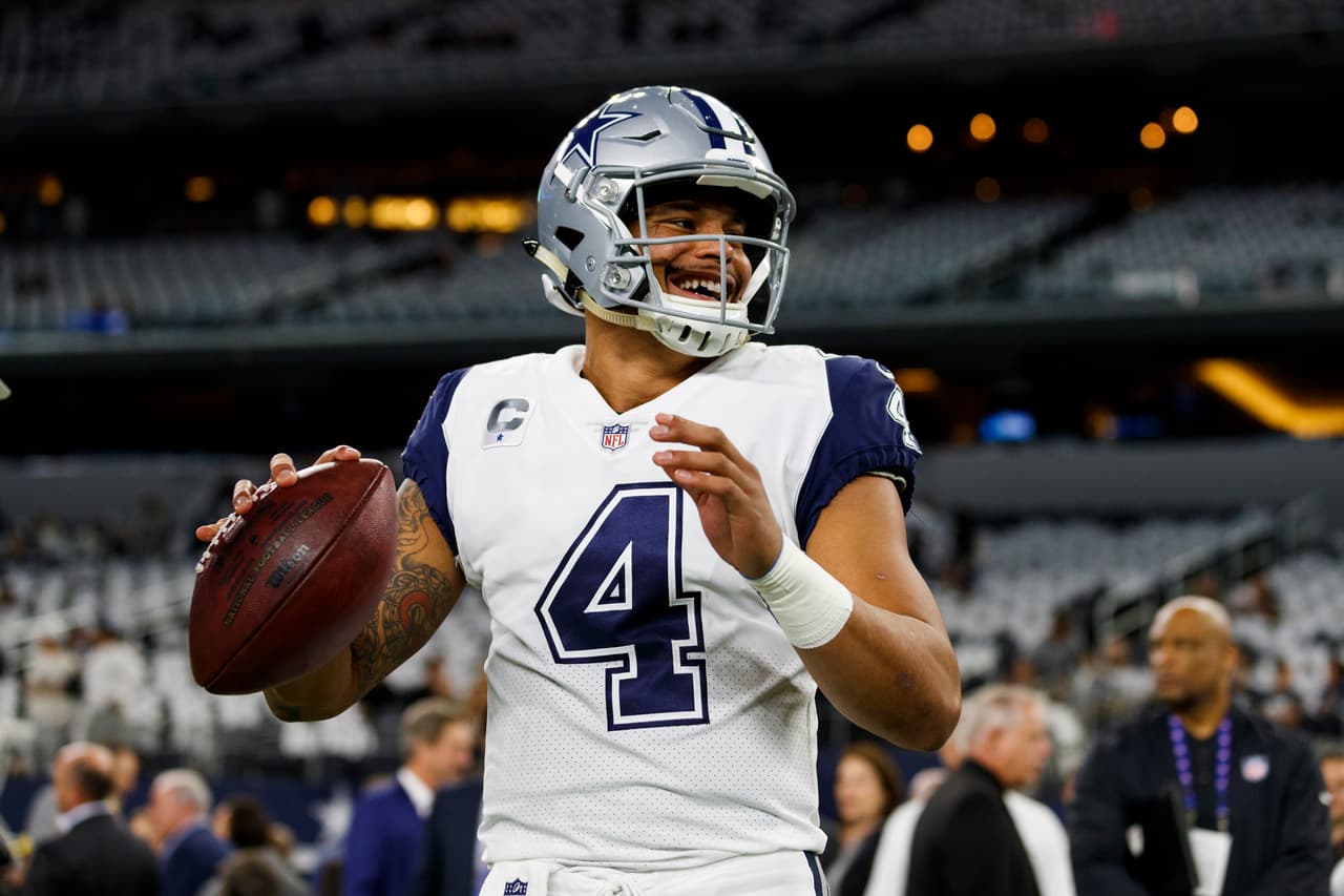 Dallas Cowboys quarterback Dak Prescott (4) smiles while warming up prior to an NFL football game against the Washington Redskins, Thursday, Nov. 30, 2017, in Arlington, Texas. The Cowboys defeated the Redskins, 38-14. (Ryan Kang via AP)