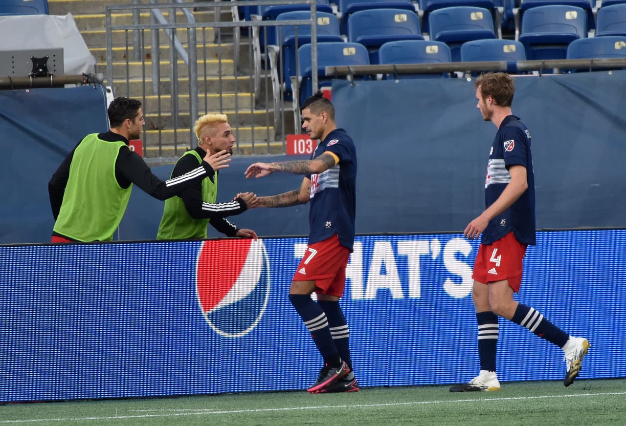 Sep 23, 2020; Foxborough, Massachusetts, USA; New England Revolution forward Gustavo Bou (7) is congratulated by his teammates after scoring a goal during the second half against the Montreal Impact at Gillette Stadium. Mandatory Credit: Bob DeChiara-USA TODAY Sports
