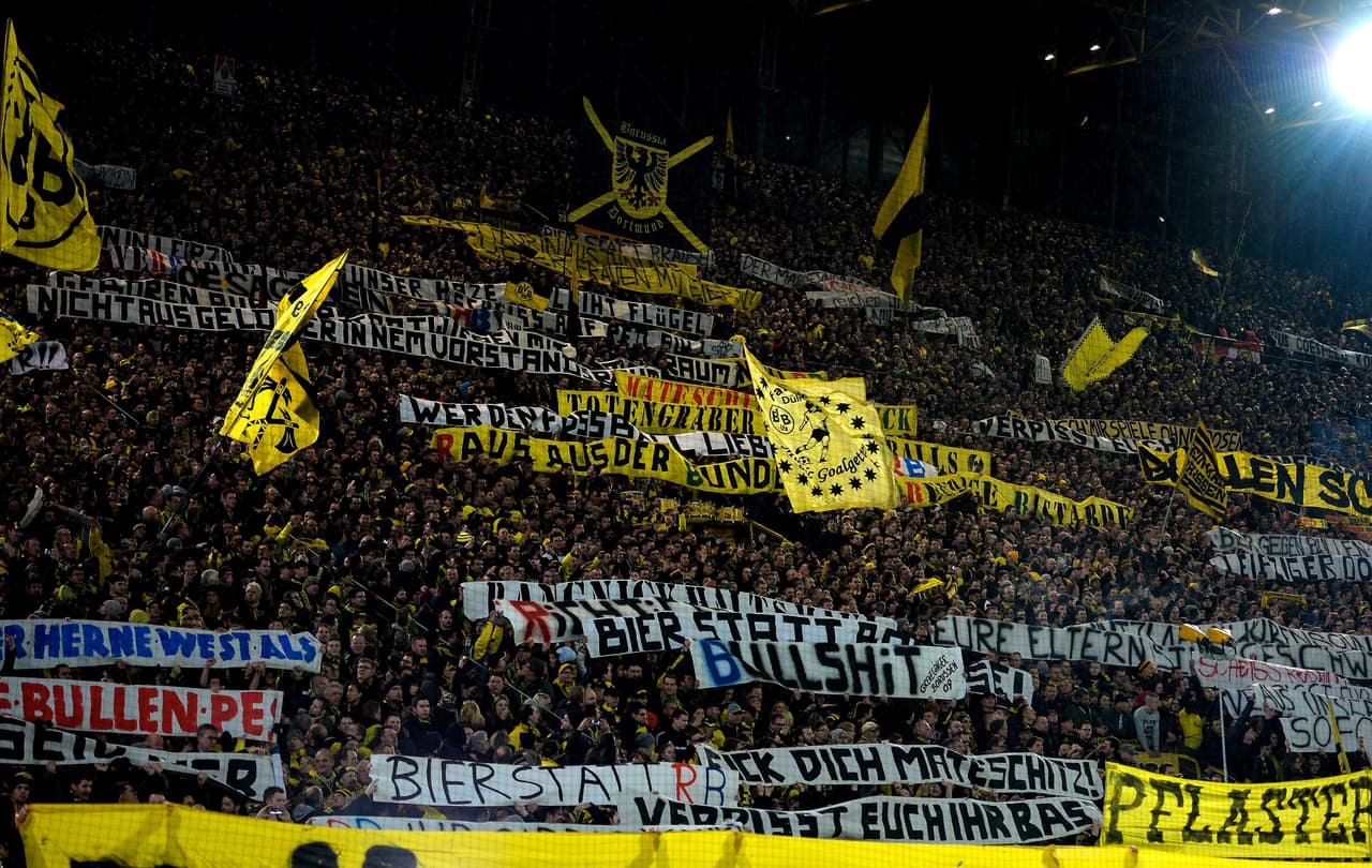 This picture taken on February 4, 2017 shows supporters of Dortmund displaying banners prior to the German First division Bundesliga football match between Borussia Dortmund and RB Leipzig, in Dortmund, western Germany. / AFP / SASCHA SCHUERMANN / RESTRICTIONS: DURING MATCH TIME: DFL RULES TO LIMIT THE ONLINE USAGE TO 15 PICTURES PER MATCH AND FORBID IMAGE SEQUENCES TO SIMULATE VIDEO. == RESTRICTED TO EDITORIAL USE == FOR FURTHER QUERIES PLEASE CONTACT DFL DIRECTLY AT + 49 69 650050 (Photo credit should read SASCHA SCHUERMANN/AFP/Getty Images)
