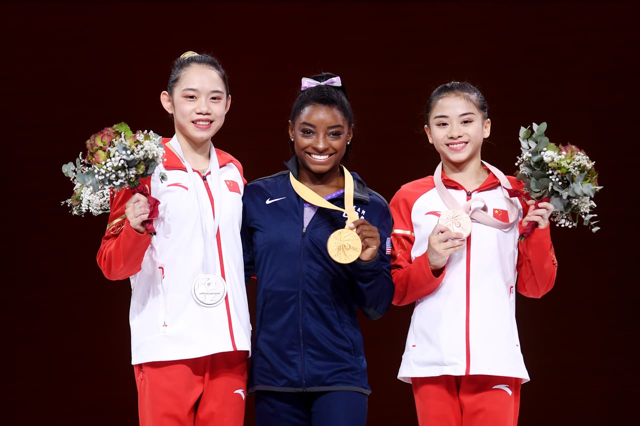STUTTGART, GERMANY - OCTOBER 13: (L-R) Silver medalist Tingting Liu of China, gold medalist Simone Biles of The United States and bronze medalist Shijia Li of China stand on the podium following the Women's Balance Beam Final during day 10 of the 49th FIG Artistic Gymnastics World Championships at Hanns-Martin-Schleyer-Halle on October 13, 2019 in Stuttgart, Germany. (Photo by Laurence Griffiths/Getty Images)