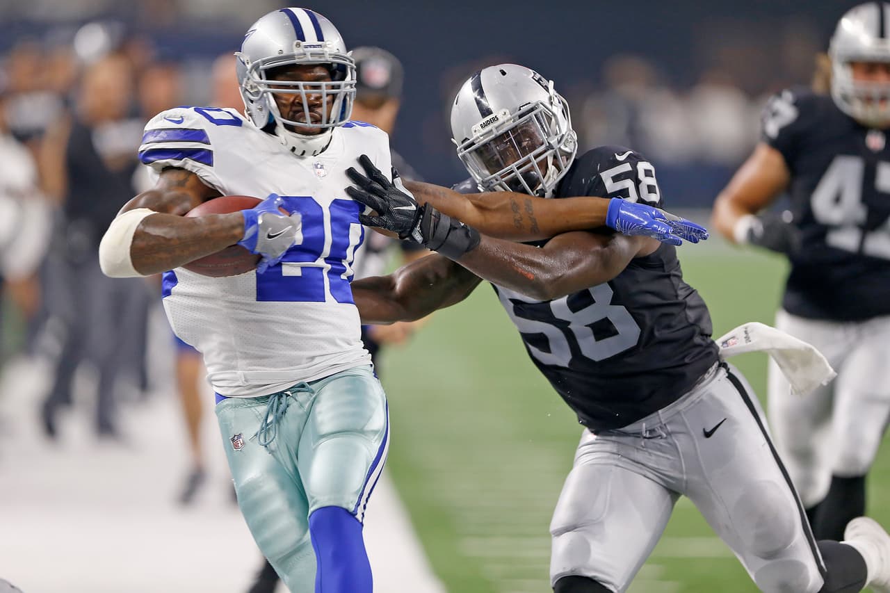 Dallas Cowboys running back Darren McFadden (20) is pushed out of bounds by Oakland Raiders linebacker Tyrell Adams (58) during an NFL preseason football game, Saturday, Aug. 26, 2017 in Arlington, Texas. The Cowboys defeated the Raiders, 24-20. (James D. Smith via AP)
