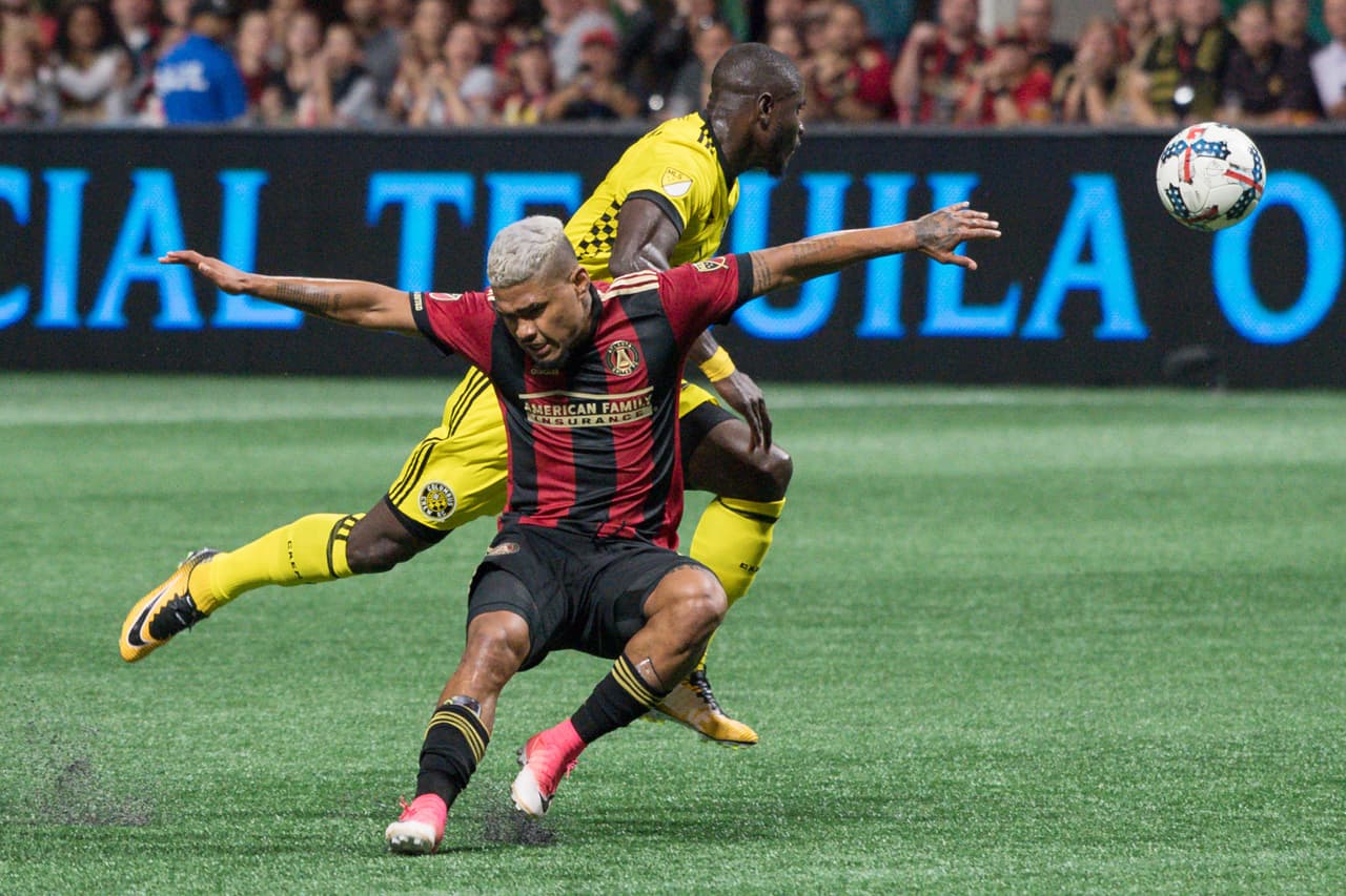 Oct 26, 2017; Atlanta, GA, USA; Atlanta United forward Josef Martinez (7) (front) collides with Columbus Crew defender Jonathan Mensah (4) during the first half during a Eastern Conference knockout round soccer game at Mercedes-Benz Stadium. Mandatory Credit: Dale Zanine-USA TODAY Sports
