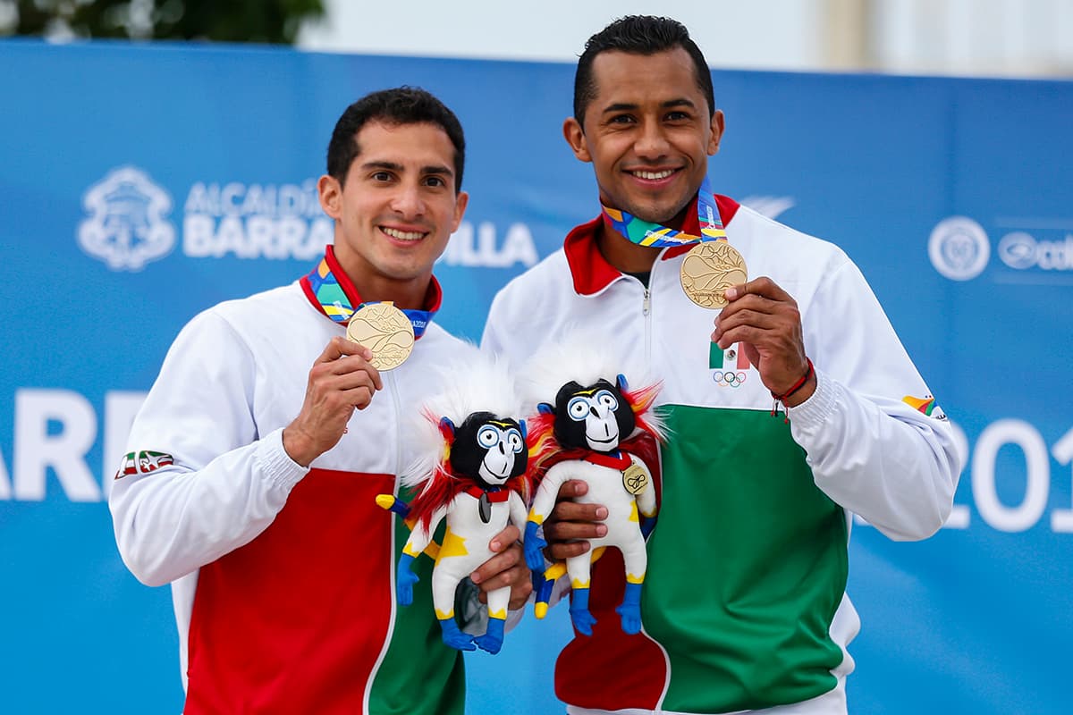 Rommel Pacheco (izquierda) y Jahir Ocampo (derecha) celebran su conquista dorada en el trampolín 3 metros de Barranquilla 2018.