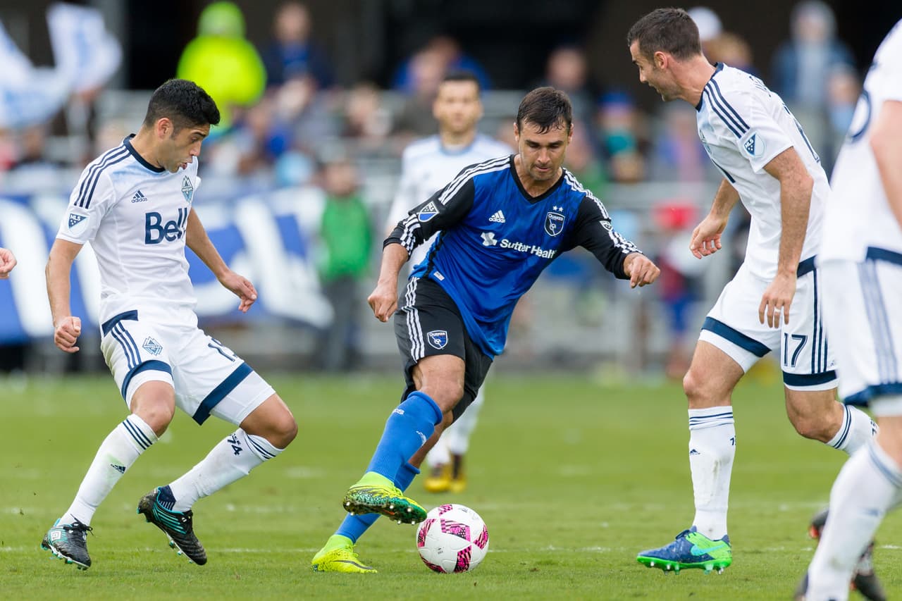 Oct 16, 2016; San Jose, CA, USA; San Jose Earthquakes forward Chris Wondolowski (8) battles for the ball with Vancouver Whitecaps midfielder Andrew Jacobson (17) in the second half at Avaya Stadium. The game ended in a 0-0 tie. Mandatory Credit: John Hefti-USA TODAY Sports