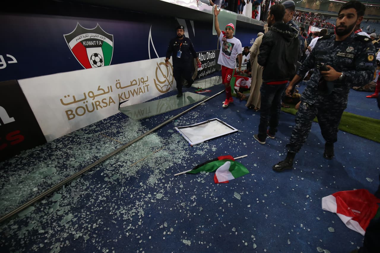 The remains of a glass barrier are seen on the ground after the barrier broke at the end of the Gulf Cup of Nations 2017 final football match between Oman and the UAE at the Sheikh Jaber al-Ahmad Stadium in Kuwait City on January 5, 2018. / AFP PHOTO / Yasser Al-Zayyat (Photo credit should read YASSER AL-ZAYYAT/AFP/Getty Images)
