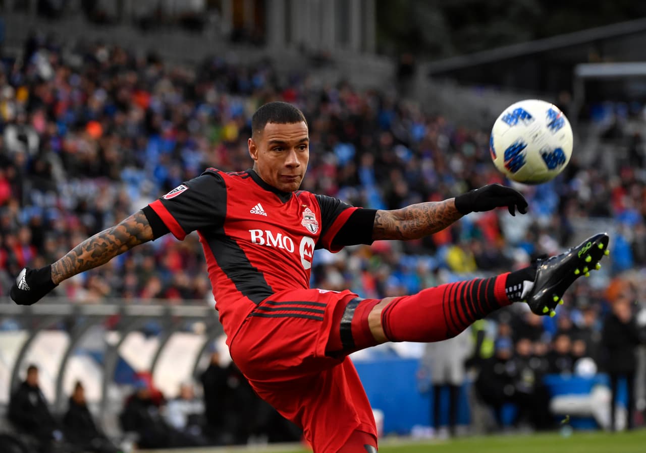 Oct 21, 2018; Montreal, Quebec, CAN; Toronto FC defender Gregory van der Wiel (9) plays the ball during the second half of the game against the Montreal Impact at Stade Saputo. Mandatory Credit: Eric Bolte-USA TODAY Sports
