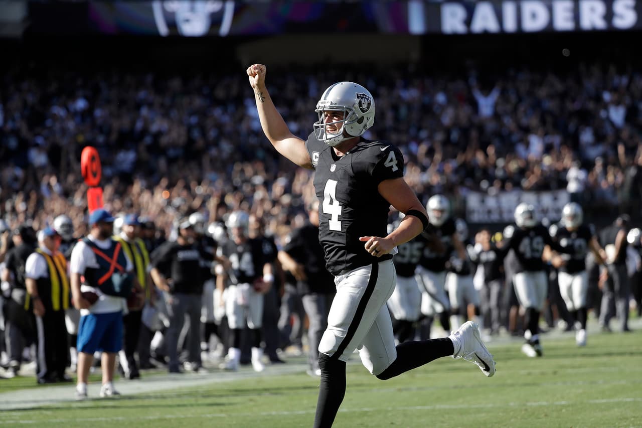 Oakland Raiders quarterback Derek Carr (4) celebrates after throwing a touchdown pass against the San Diego Chargers during the second half of an NFL football game in Oakland, Calif., Sunday, Oct. 9, 2016. (AP Photo/Marcio Jose Sanchez)