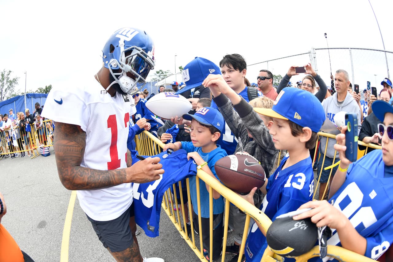 New York Giants wide receiver Odell Beckham (13) signs autographs for fans following practice during NFL football training camp on July 29, 2017 in East Rutherford, N.J. (Evan Pinkus via AP)