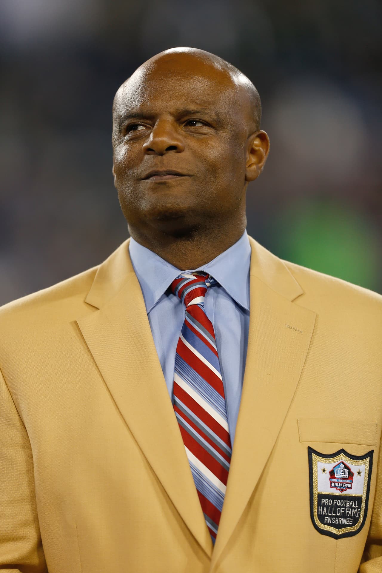 Former Houston Oilers player and Hall of Fame member Warren Moon looks on as he is honored at halftime during a week 15 NFL football game between the New York Jets against the Tennessee Titans in Nashville, Tennessee on December 17, 2012. The Titans defeated the Jets 14-10. (AP Photo/Scott Boehm)