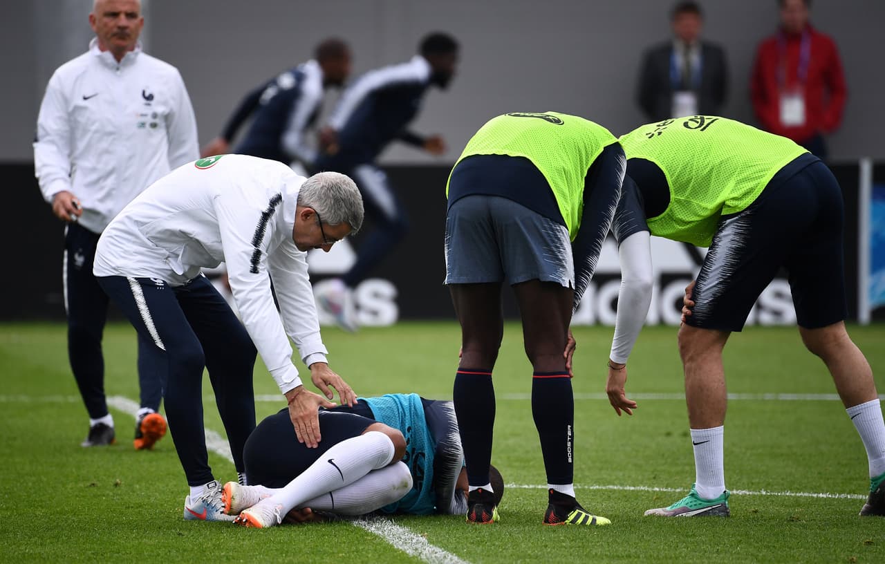 France's forward Kylian Mbappe (C) reacts after getting injured during a training session at the Glebovets stadium in Istra, on June 12, 2018, ahead of Russia 2018 World Cup football tournament. (Photo by FRANCK FIFE / AFP) (Photo credit should read FRANCK FIFE/AFP/Getty Images)